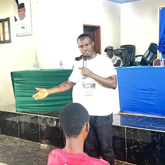 Abdulai speaking with a microphone in a hall