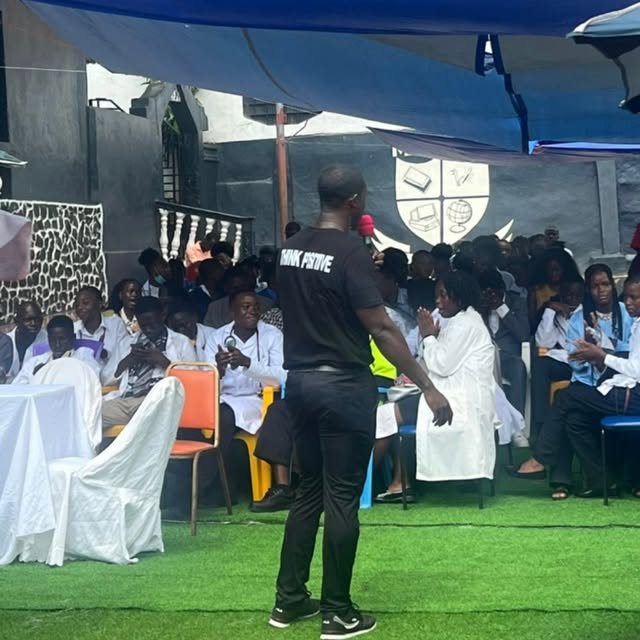 Abdulai addressing students in white coats